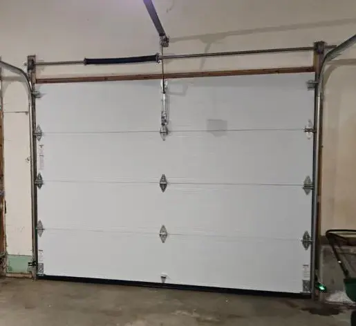 Garage Door Track and Roller Repair Skilled Garage Door Repair in Dedham repairing damaged tracks and worn rollers