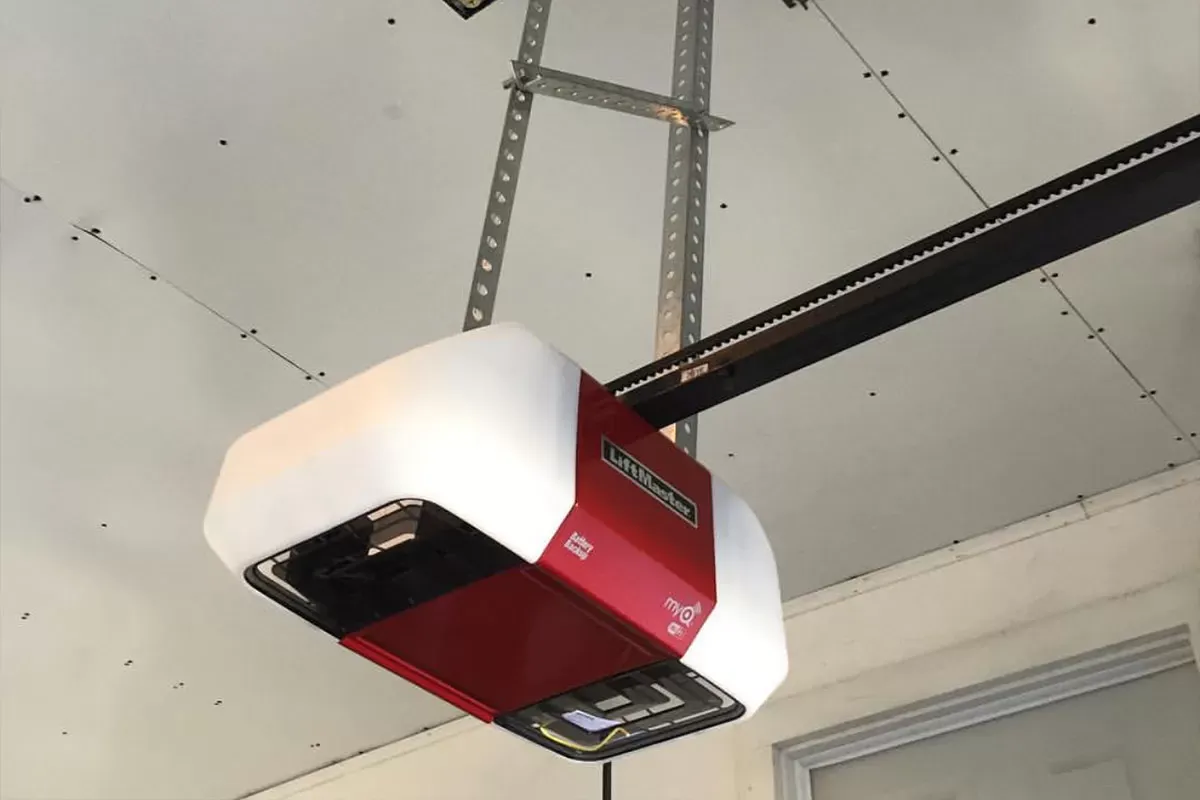 Garage Door Opener Repair Service Skilled technician performing Garage Door Repair in Brookline by repairing a faulty garage door opener
