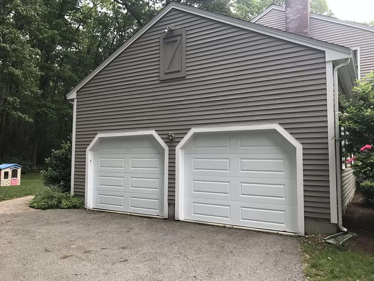 Garage Door Opener Repair Skilled technician performing Garage Door Repair in Cambridge on a malfunctioning garage door opener